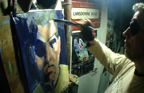 Rod Coyne paints a self-portrait method wearing an eyepatch.