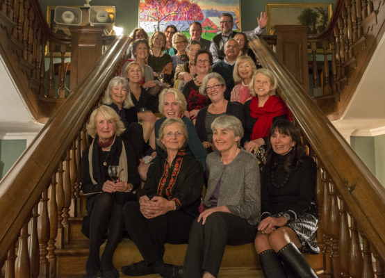 Twenty six artists seated on the grand staircase.