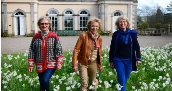 The Jameson sisters wade through daffodils in front of Tourin House.