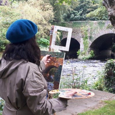 Photo depicting a student using a view finder to create a balanced composition from the June Painting Workshop in 2019.