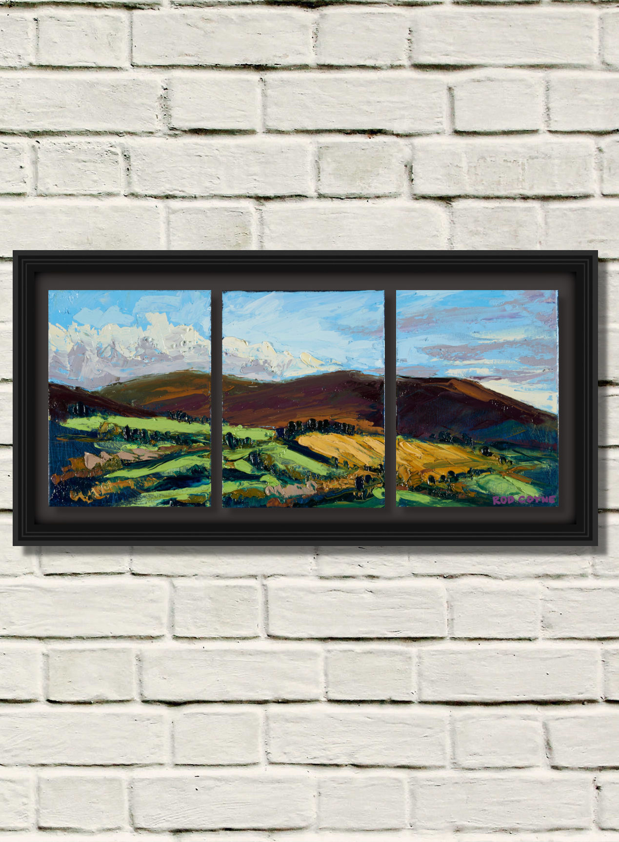 artist rod coyne's triptych painting "Croghan from Aughrim" is shown here in a single black frame on a white brick wall.