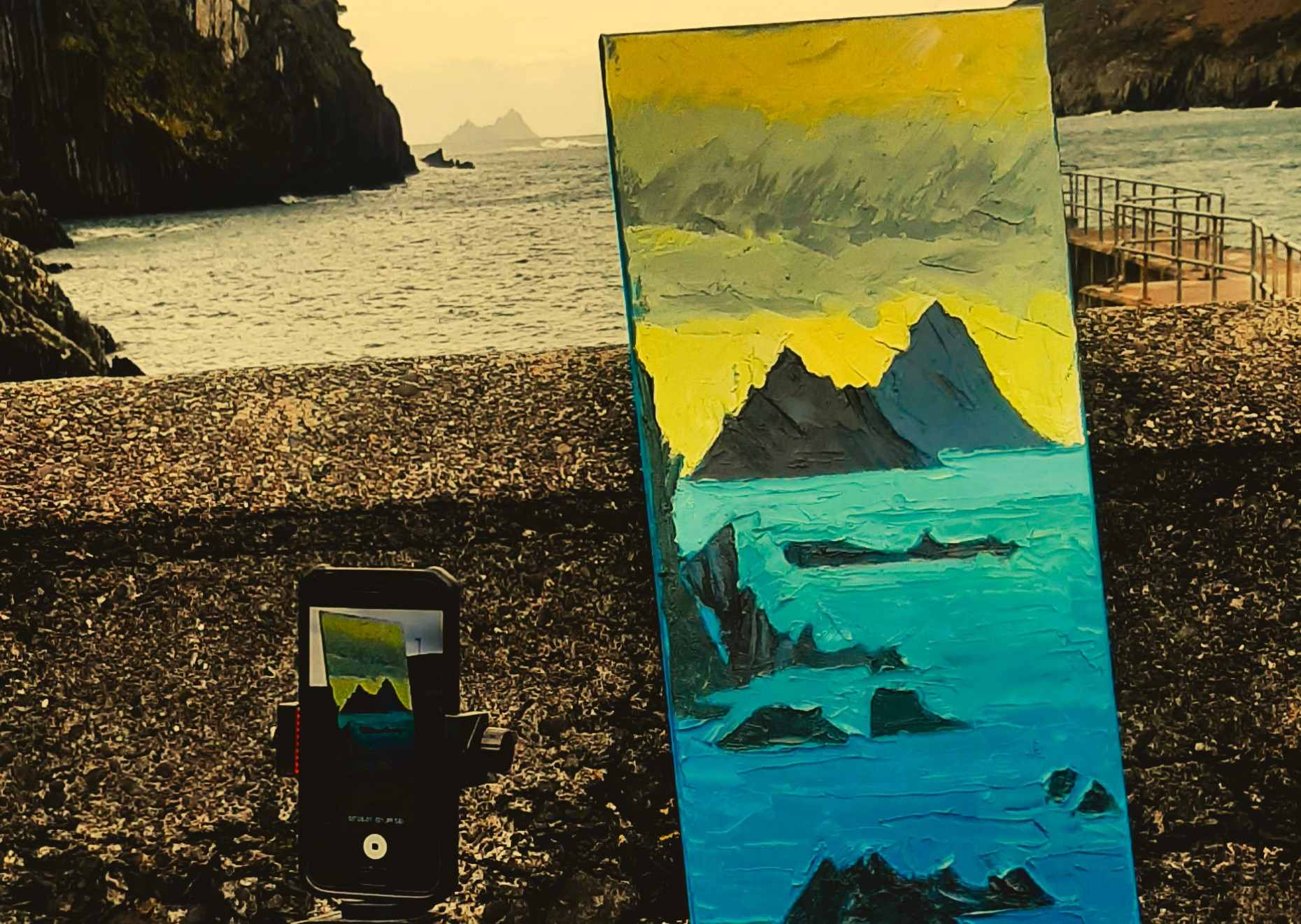 rod-cast : painting the wild atlantic way blog photo showing the skelligs on the horizon, painted on a canvas and in a camera view finder simitainiously